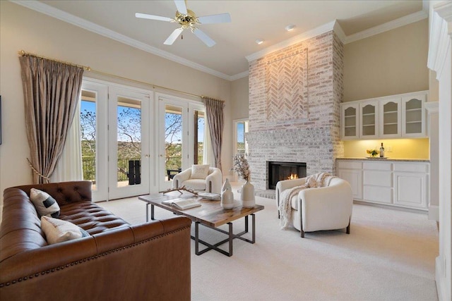 13601 Lone Rider Trl, Austin, TX 78738 - living room with light carpet, ornamental molding, a fireplace, a towering ceiling, and ceiling fan