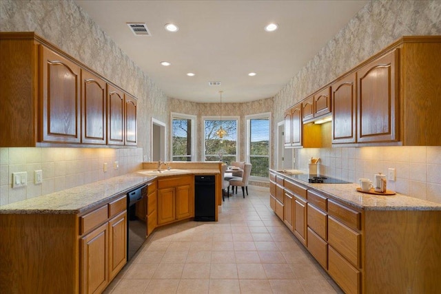 13601 Lone Rider Trl, Austin, TX 78738 - kitchen featuring black appliances, tasteful backsplash, recessed lighting, light stone countertops, and a peninsula