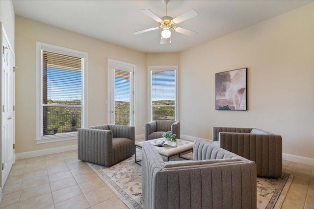 interior space with light tile patterned floors, baseboards, and ceiling fan