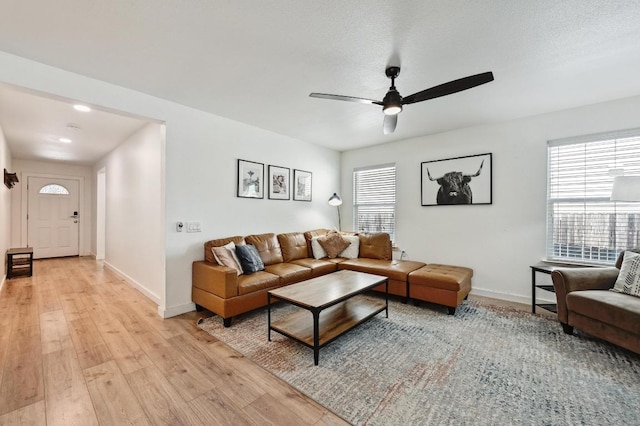 7004 Ashen Ln, Austin, TX 78747 - living area featuring ceiling fan, light wood finished floors, and healthy amount of natural light