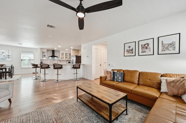 7004 Ashen Ln, Austin, TX 78747 - living room featuring light wood-type flooring, a chandelier, ceiling fan, and recessed lighting