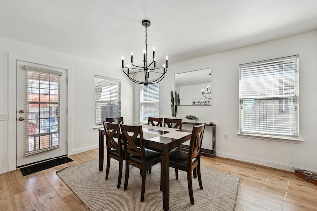 7004 Ashen Ln, Austin, TX 78747 - dining space with a chandelier and light wood-style flooring