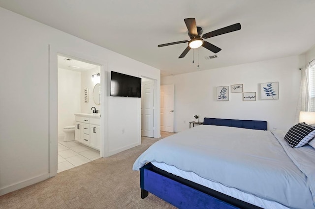 7004 Ashen Ln, Austin, TX 78747 - bedroom with light carpet, light tile patterned floors, ensuite bath, and ceiling fan
