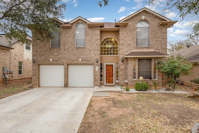 2708 Winding Brook Dr, Austin, TX 78748 - traditional home with concrete driveway, an attached garage, and brick siding