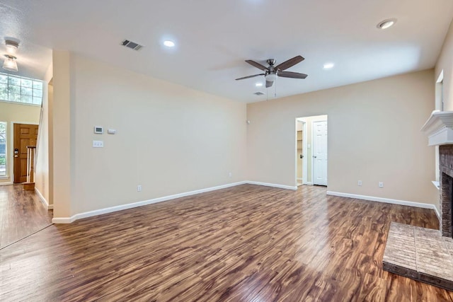 2708 Winding Brook Dr, Austin, TX 78748 - unfurnished living room featuring a brick fireplace, a ceiling fan, wood finished floors, baseboards, and recessed lighting