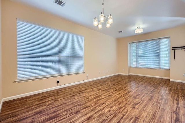 2708 Winding Brook Dr, Austin, TX 78748 - empty room with a chandelier, wood finished floors, and baseboards