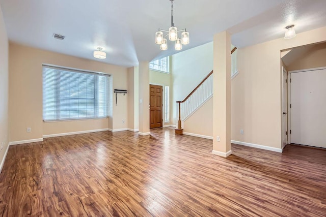 2708 Winding Brook Dr, Austin, TX 78748 - unfurnished living room with plenty of natural light, wood finished floors, a chandelier, and stairway