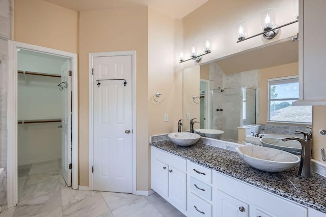 2708 Winding Brook Dr, Austin, TX 78748 - full bathroom featuring a stall shower, double vanity, marble finish flooring, and a walk in closet