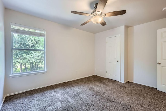 2708 Winding Brook Dr, Austin, TX 78748 - unfurnished bedroom featuring multiple windows, carpet floors, a ceiling fan, and baseboards