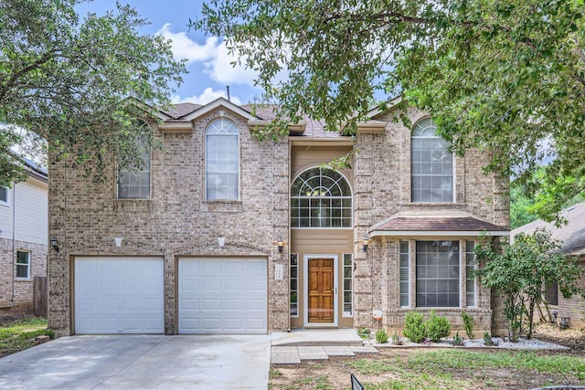 2708 Winding Brook Dr, Austin, TX 78748 - traditional-style house with driveway, an attached garage, and brick siding