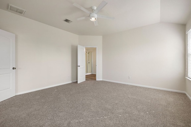 unfurnished room with baseboards, visible vents, a ceiling fan, and carpet