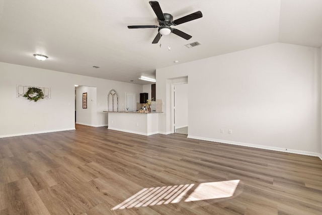 unfurnished living room with visible vents, baseboards, ceiling fan, and wood finished floors