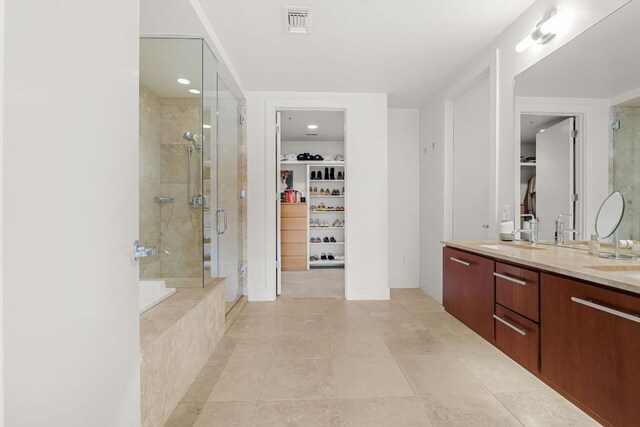 210 Lee Barton Dr Unit 308, Austin, TX 78704 - full bath featuring a walk in closet, a stall shower, and double vanity