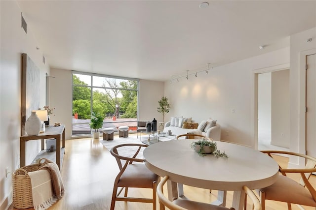 210 Lee Barton Dr Unit 308, Austin, TX 78704 - dining area featuring a wall of windows and wood finished floors