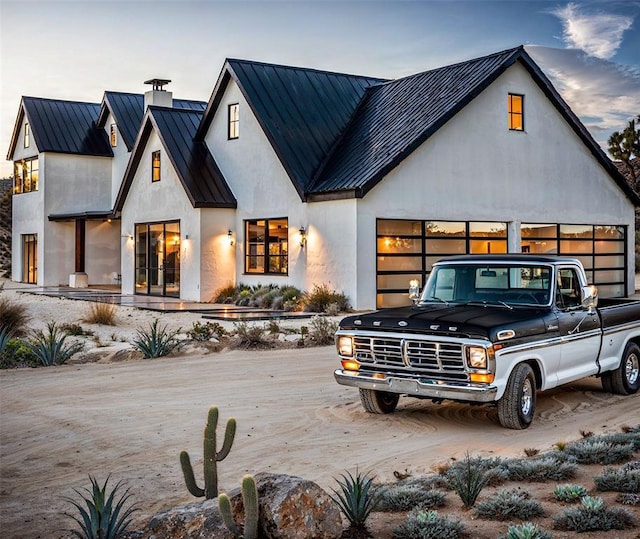 2121 Camino Way, Canyon Lake, TX 78133 - modern farmhouse style home with a standing seam roof, a metal roof, stucco siding, a garage, and driveway