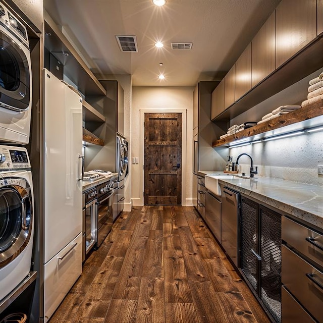2121 Camino Way, Canyon Lake, TX 78133 - washroom with stacked washer / drying machine, dark wood finished floors, and recessed lighting