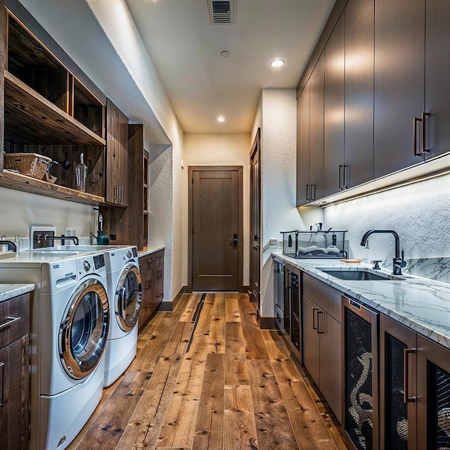 2121 Camino Way, Canyon Lake, TX 78133 - laundry room with wine cooler, light wood-style floors, separate washer and dryer, and recessed lighting