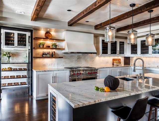 2121 Camino Way, Canyon Lake, TX 78133 - kitchen with range hood, double oven range, beamed ceiling, tasteful backsplash, and white cabinets