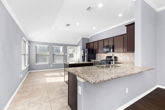 464 Evening Star, Kyle, TX 78640 - kitchen featuring black microwave, refrigerator with ice dispenser, a sink, a center island, and dark brown cabinets