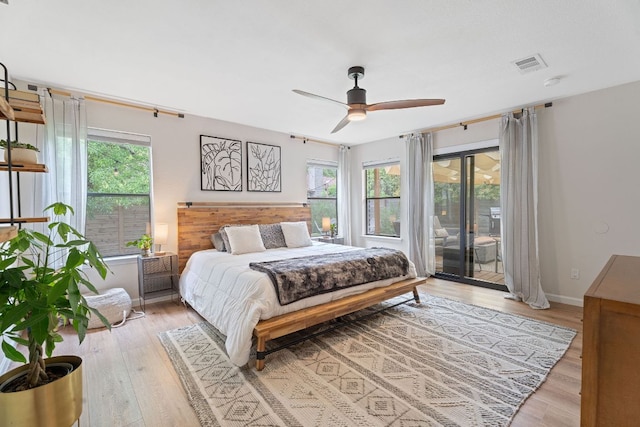 9706 Woodshire Dr, Austin, TX 78748 - bedroom with access to exterior, multiple windows, and light wood-type flooring