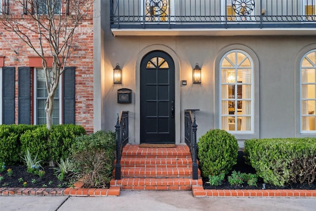1810 W 35th St, Austin, TX 78703 - view of exterior entry with a balcony and stucco siding