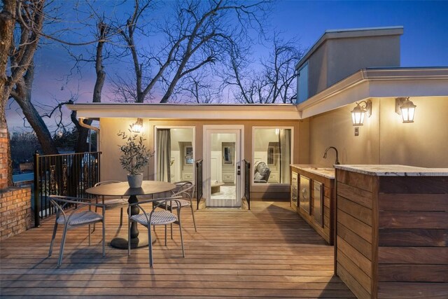 deck at dusk with a sink