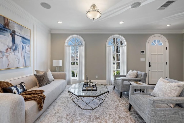 living area with plenty of natural light, visible vents, and ornamental molding