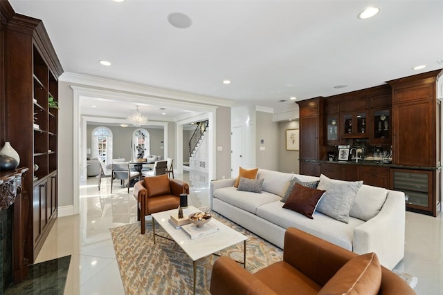 1810 W 35th St, Austin, TX 78703 - living area with beverage cooler, stairway, light tile patterned floors, ornamental molding, and a chandelier