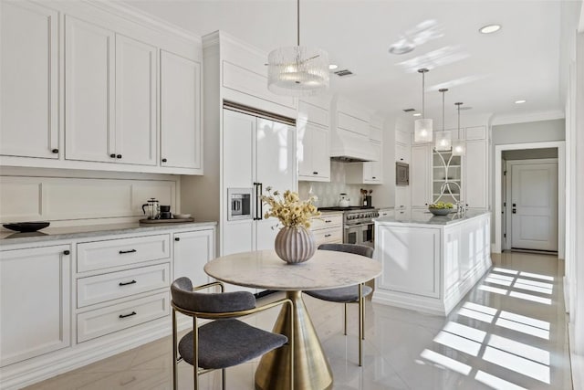 1810 W 35th St, Austin, TX 78703 - kitchen featuring light tile patterned flooring, white cabinets, ornamental molding, a center island with sink, and light countertops