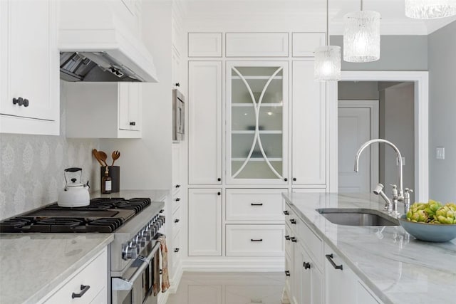 1810 W 35th St, Austin, TX 78703 - kitchen with stainless steel range, custom range hood, white cabinetry, glass insert cabinets, and hanging light fixtures