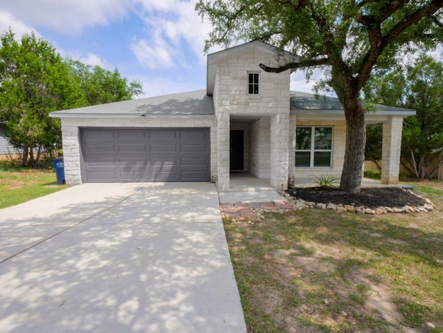 21711 Crystal Way, Lago Vista, TX 78645 - view of front of property featuring an attached garage, driveway, and stone siding
