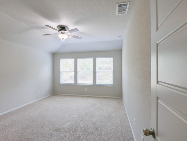 21711 Crystal Way, Lago Vista, TX 78645 - spare room featuring a ceiling fan, light colored carpet, and vaulted ceiling