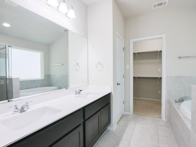 21711 Crystal Way, Lago Vista, TX 78645 - full bathroom with a garden tub, tile patterned flooring, double vanity, a walk in closet, and a shower with door