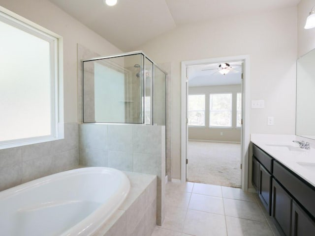 21711 Crystal Way, Lago Vista, TX 78645 - full bathroom featuring a garden tub, double vanity, a shower stall, tile patterned floors, and a ceiling fan