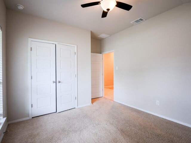 21711 Crystal Way, Lago Vista, TX 78645 - unfurnished bedroom featuring carpet floors, a closet, and a ceiling fan