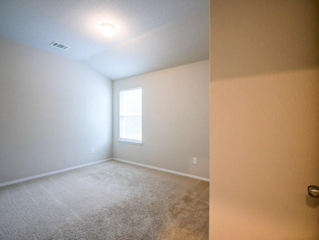 21711 Crystal Way, Lago Vista, TX 78645 - empty room featuring light colored carpet and vaulted ceiling