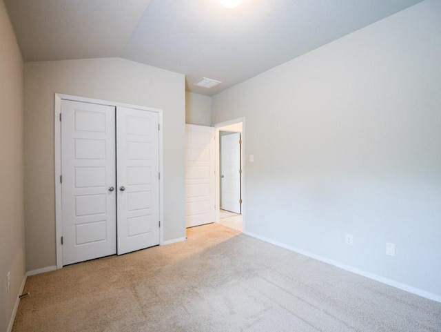 21711 Crystal Way, Lago Vista, TX 78645 - unfurnished bedroom with carpet, vaulted ceiling, and a closet