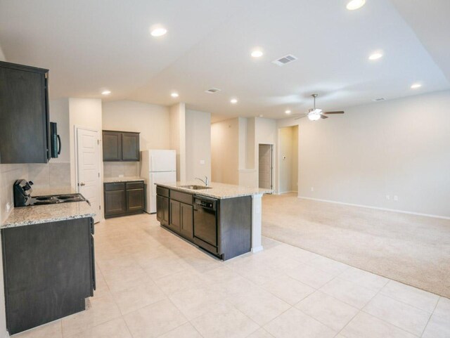 21711 Crystal Way, Lago Vista, TX 78645 - kitchen with black appliances, light carpet, ceiling fan, recessed lighting, and an island with sink
