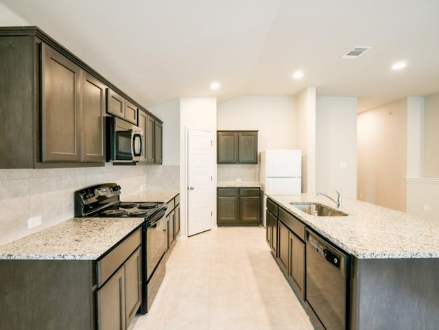 21711 Crystal Way, Lago Vista, TX 78645 - kitchen with black electric range, dishwashing machine, stainless steel microwave, freestanding refrigerator, and decorative backsplash