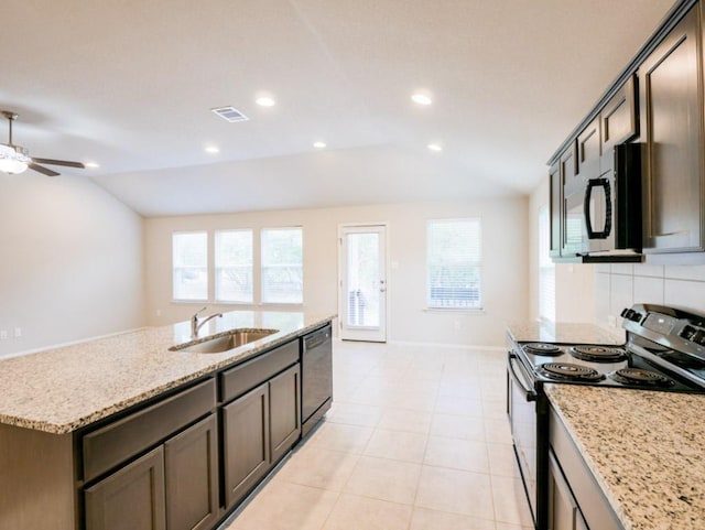 21711 Crystal Way, Lago Vista, TX 78645 - kitchen featuring appliances with stainless steel finishes, lofted ceiling, a ceiling fan, light stone countertops, and a kitchen island with sink