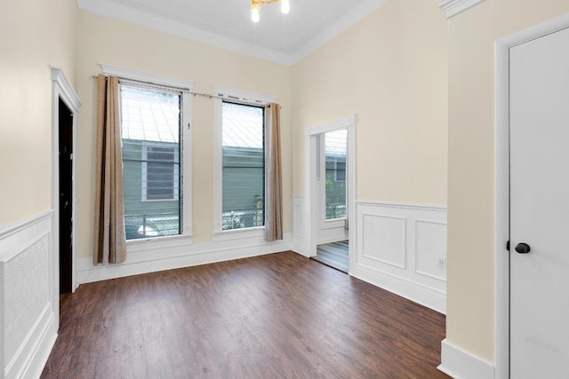 2705 E 2nd St, Austin, TX 78702 - empty room featuring wainscoting, dark wood-style floors, and ornamental molding