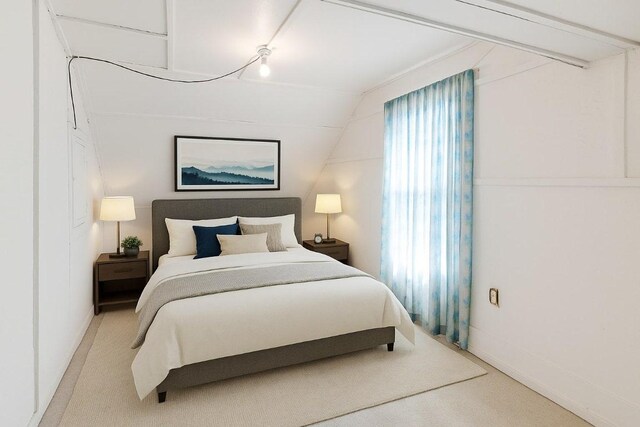 2705 E 2nd St, Austin, TX 78702 - bedroom featuring carpet, vaulted ceiling, and baseboards