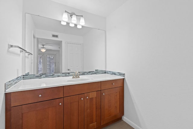 7685 Northcross Dr Unit 728, Austin, TX 78757 - bathroom with vanity, a ceiling fan, and decorative backsplash