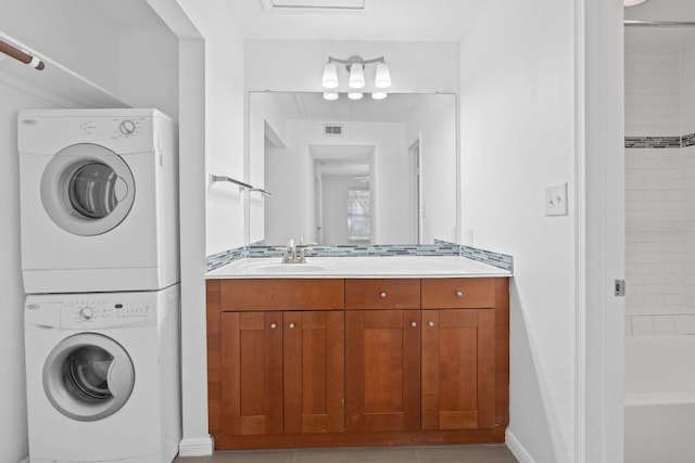 7685 Northcross Dr Unit 728, Austin, TX 78757 - washroom featuring stacked washing machine and dryer