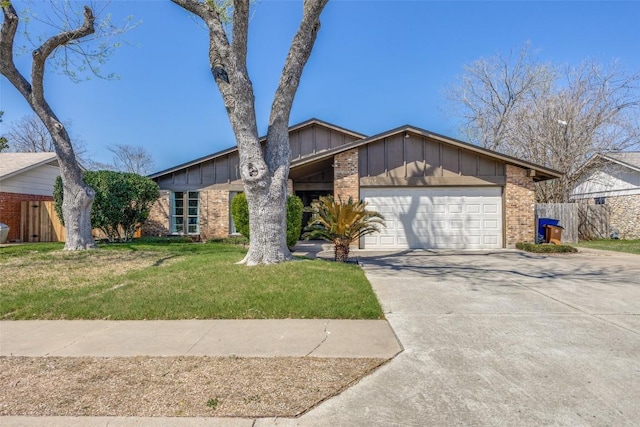 mid-century modern home featuring concrete driveway, board and batten siding, brick siding, a front yard, and a garage
