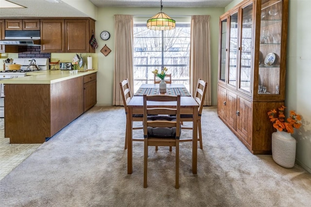 dining space featuring light colored carpet