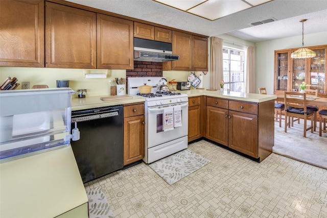 kitchen featuring under cabinet range hood, white gas range, light countertops, visible vents, and black dishwasher