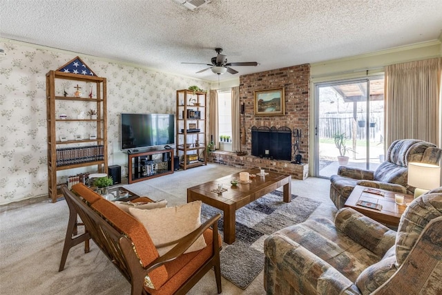 living area with a textured ceiling, wallpapered walls, ceiling fan, a fireplace, and light colored carpet