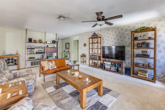 carpeted living room with wallpapered walls, visible vents, a textured ceiling, and ceiling fan