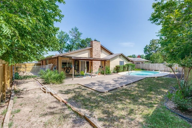 10116 Willfield Dr, Austin, TX 78753 - back of property with a patio area, a fenced backyard, and a chimney